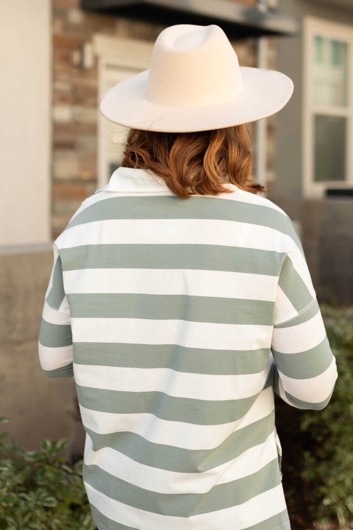 Back view of a sage striped top