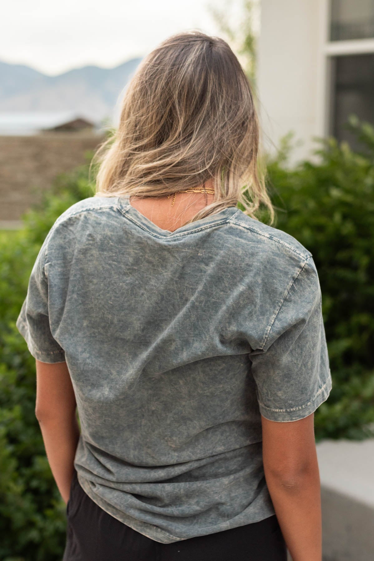 Back view of a stone grey tee
