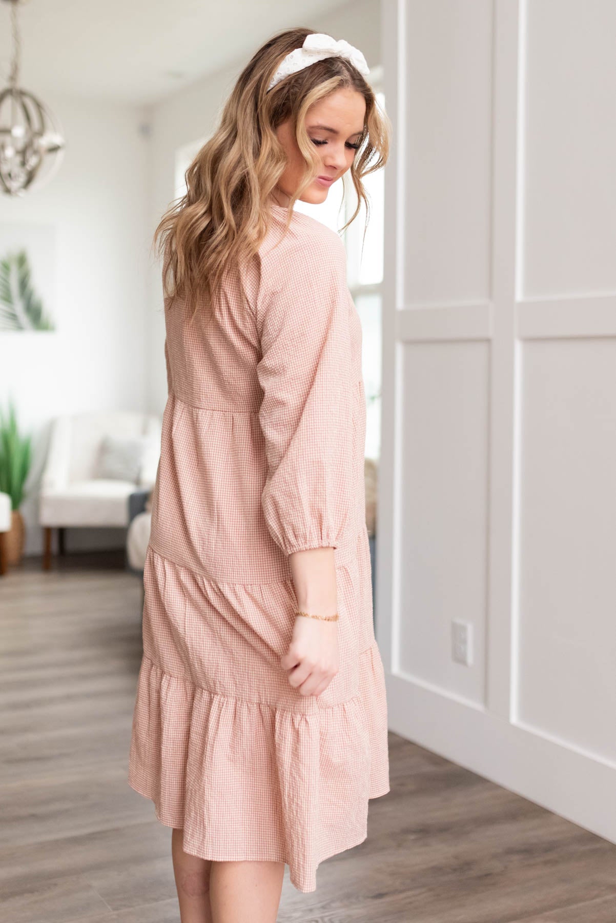 Side view of a blush tiered dress