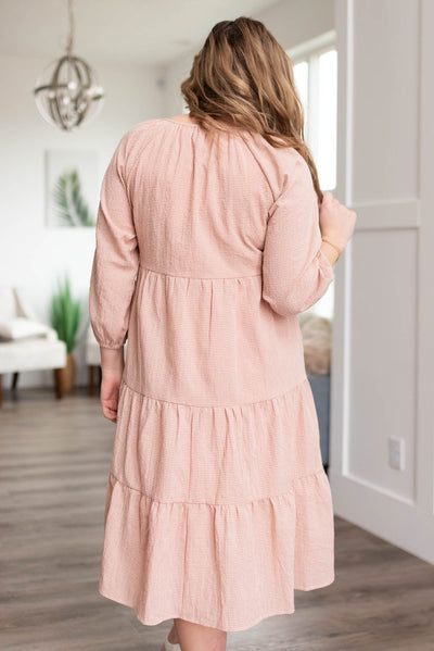 Back view of a blush tiered dress