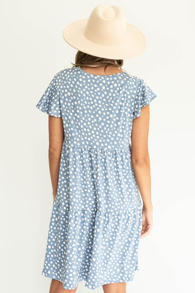 Back view of a knee length blue dress