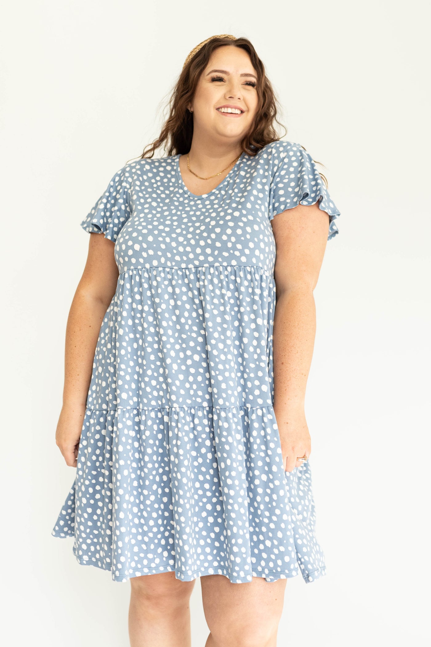 Front view of a short sleeve, knee length blue dress