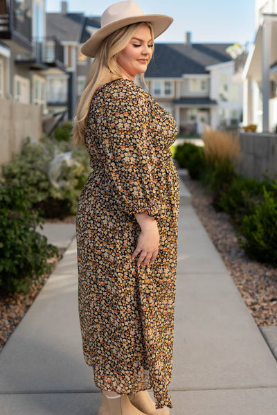 Side view of a black floral tiered dress