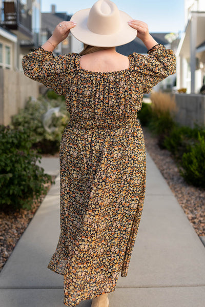 Back view of a black floral tiered dress