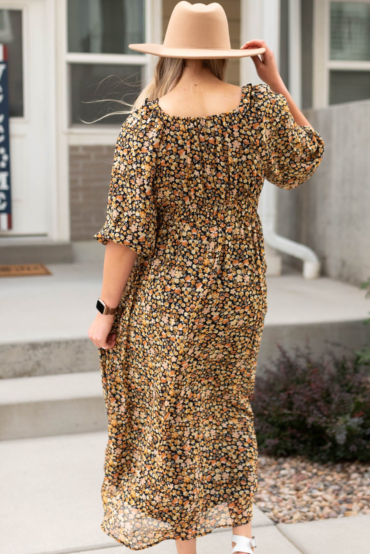 Back view of a black floral tiered dress