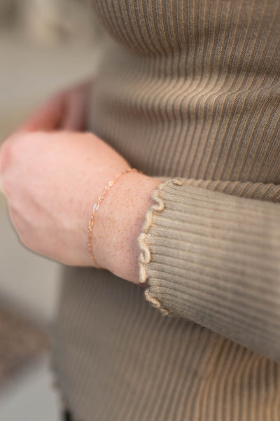 Surged hem and cuff of a latte sweater