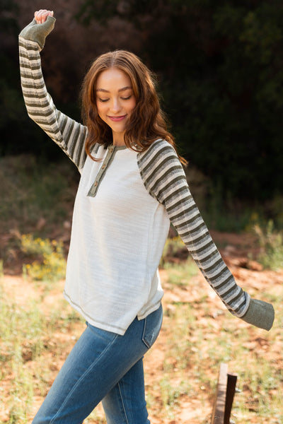 Side view of a long sleeve olive top