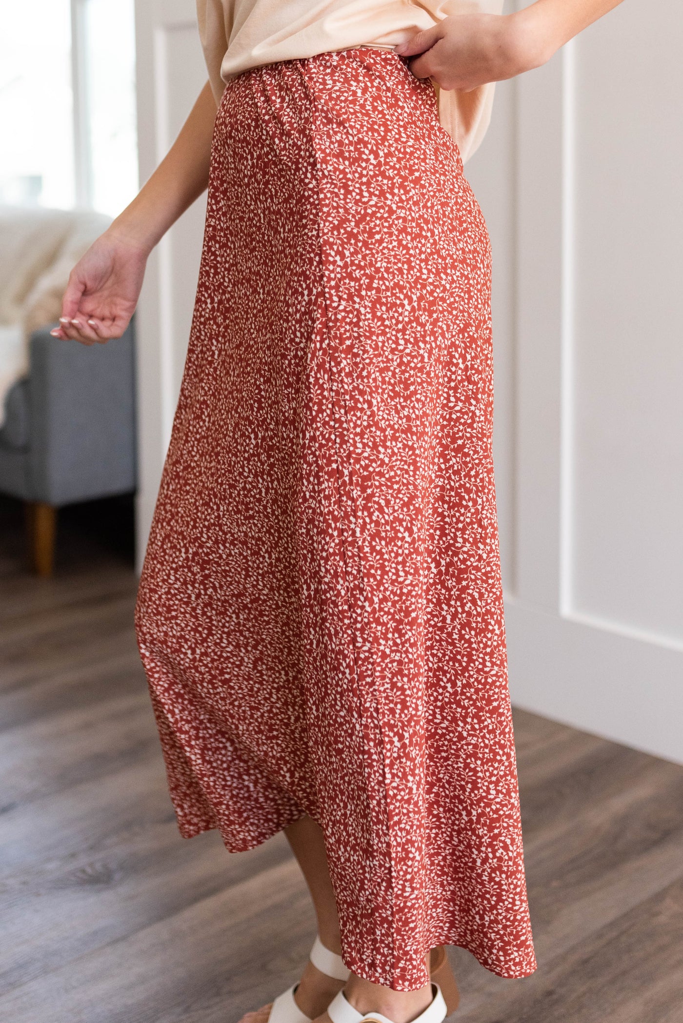Side view of the terracotta red floral skirt