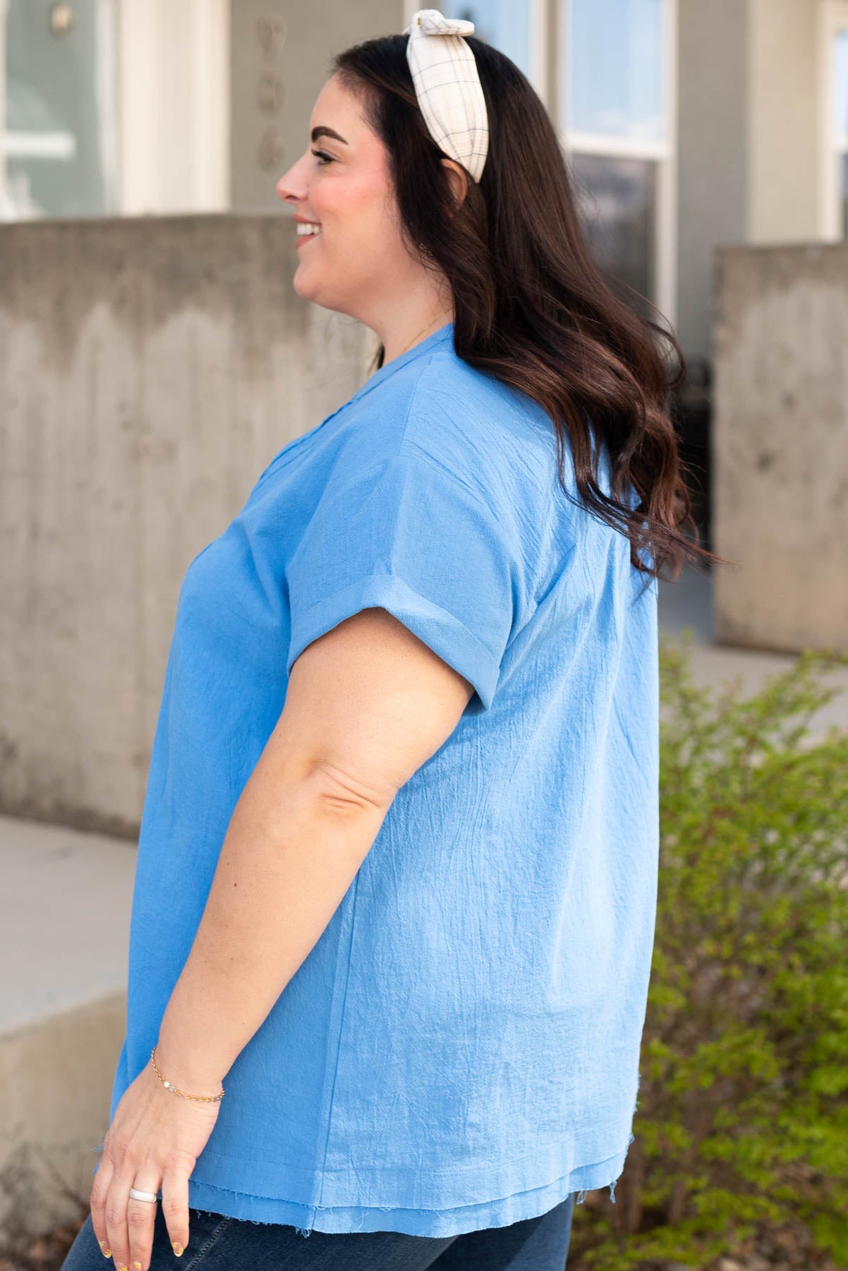 Side view of the plus size blue v-neck top