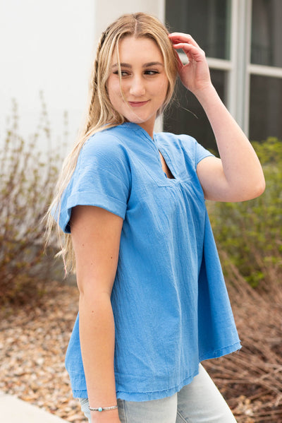 Side view of the blue v-neck top