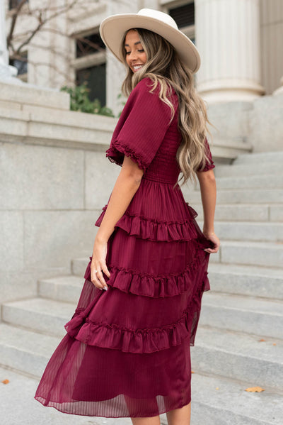 Side view of a burgundy tiered dress
