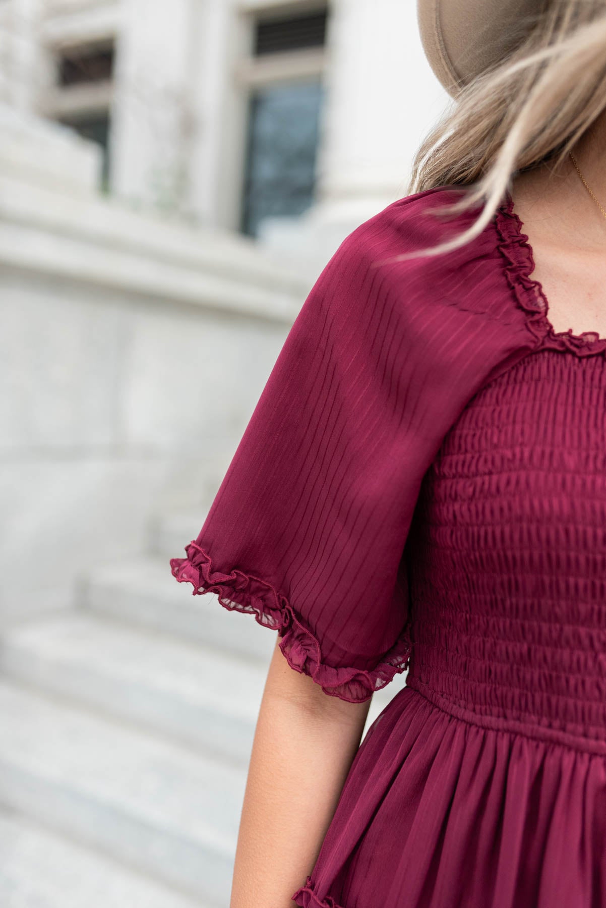 Close up of the sleeve on a burgundy tiered dress