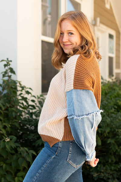 Side view of a taupe sweater