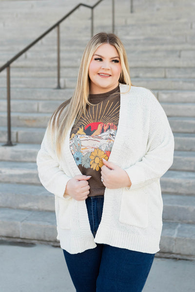 Front view of a plus size off white cardigan