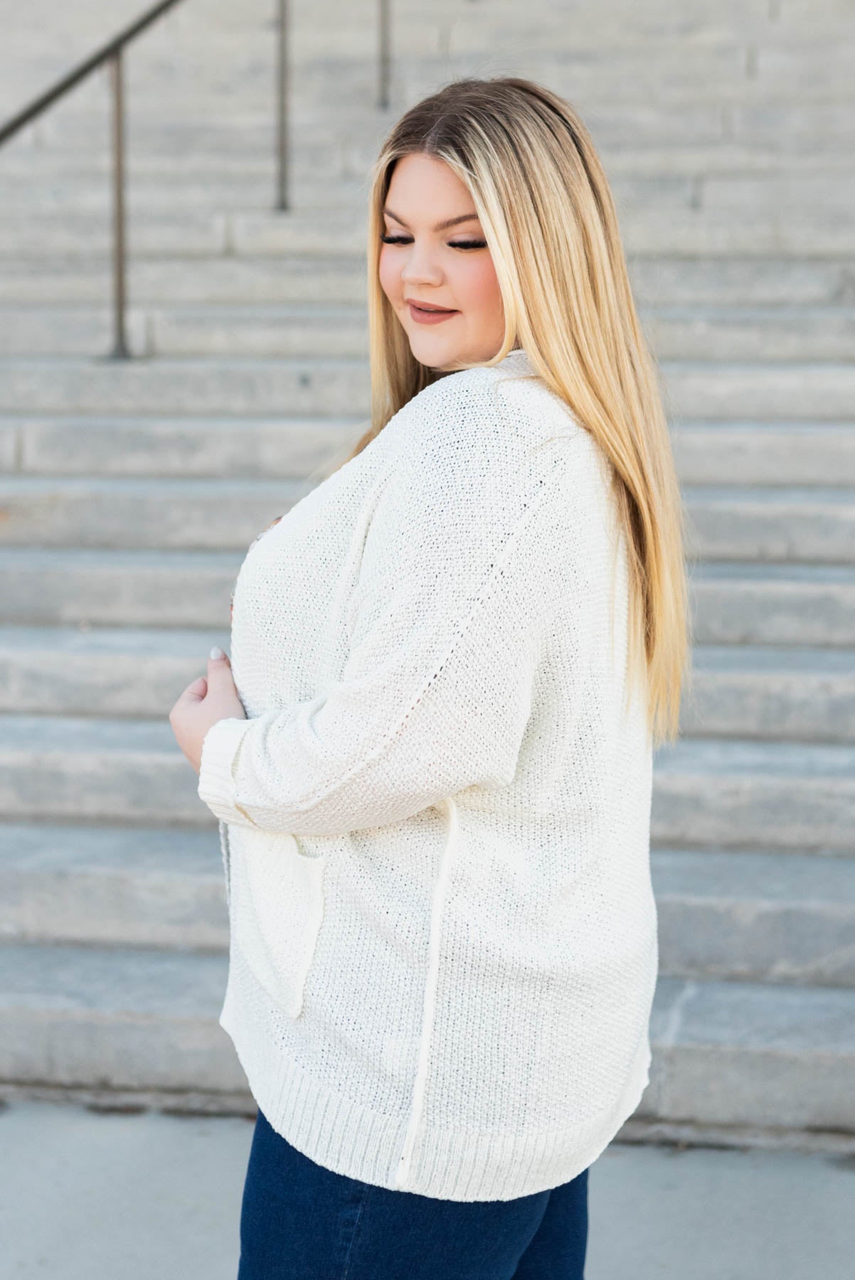 Side view of the plus size off white cardigan
