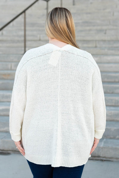 Back view of a plus size off white cardigan