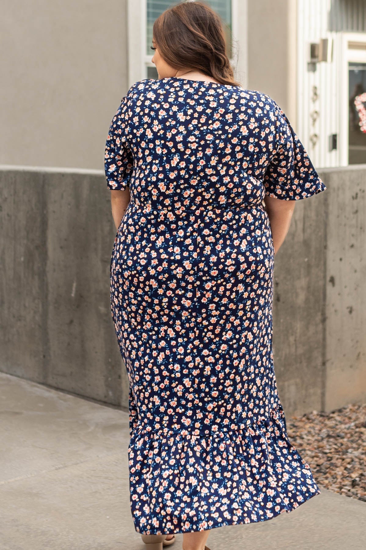 Back view of a plus size navy floral dress