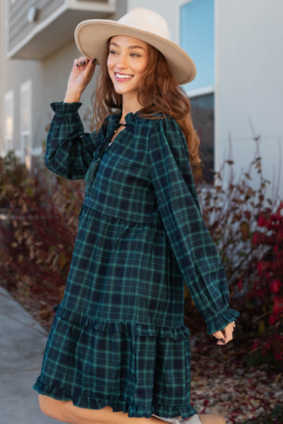 Side view of a plaid hunter green tiered dress