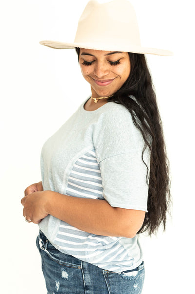Side view of a short sleeve soft blue top with stripes on the sides.