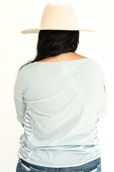 Back view of a short sleeve soft blue top with stripes on the sides.