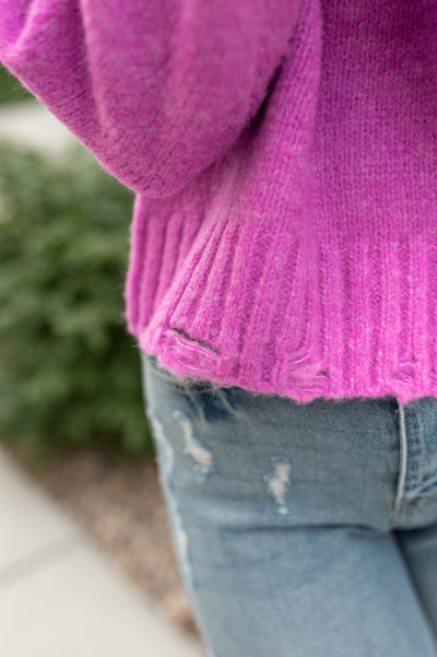 Close up of the hem on a orchid sweater