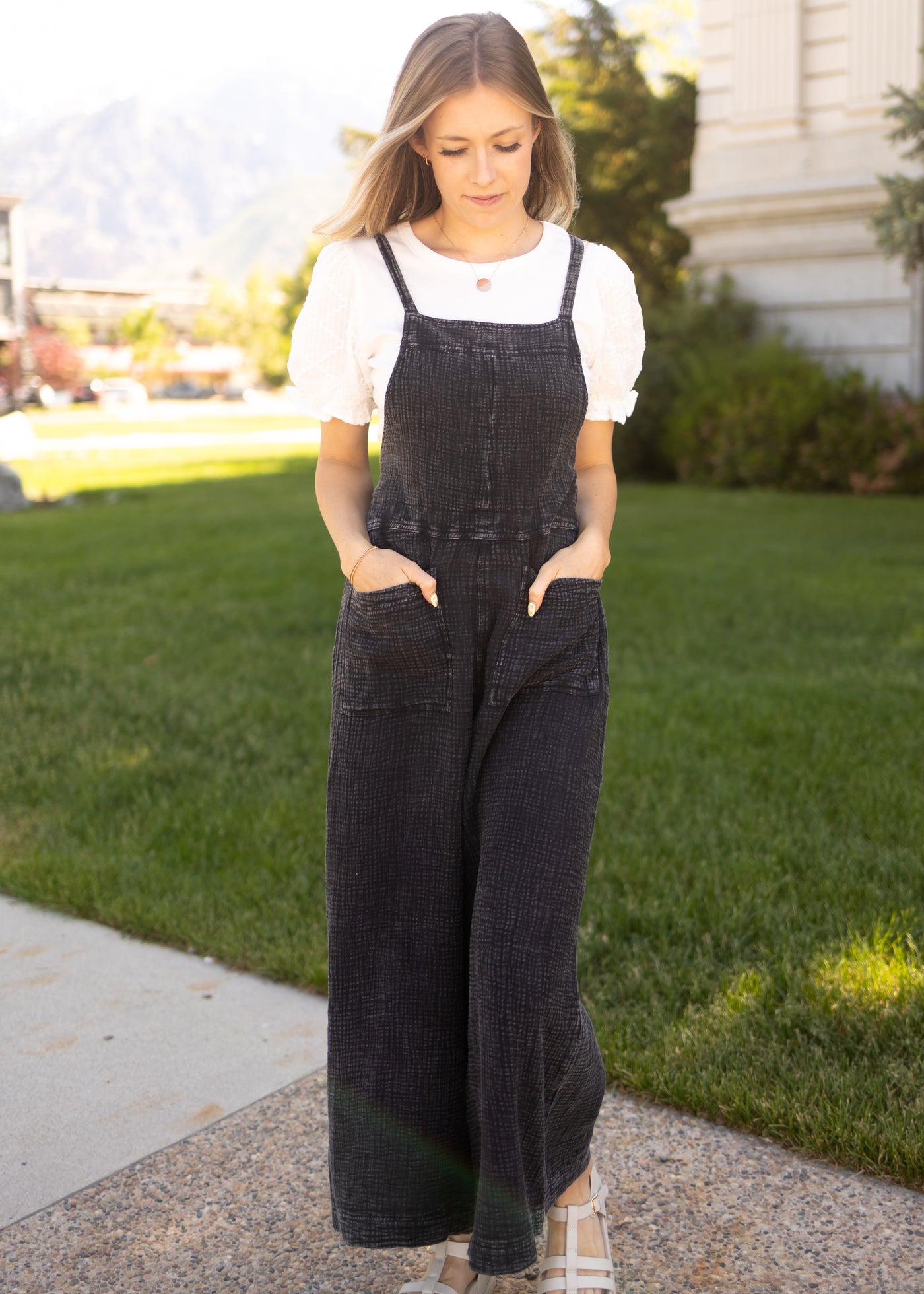 Front view of a black jumpsuit with pockets