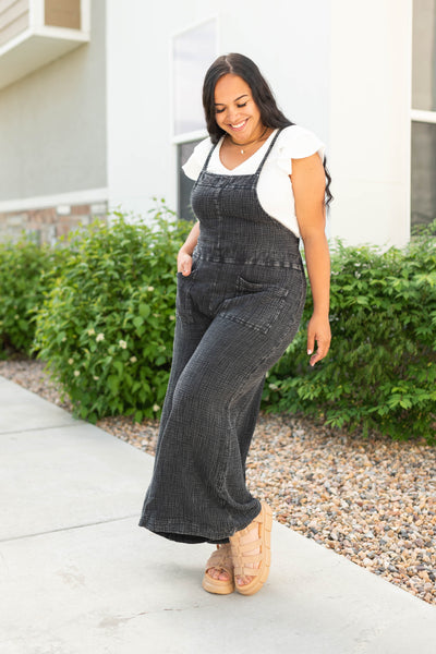 Black jumpsuit that has pockets in the front and back