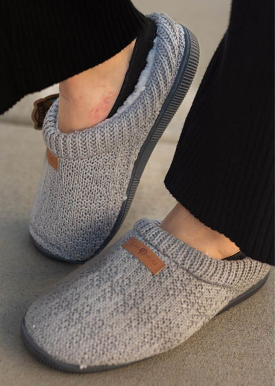 Side view of grey knitted slippers