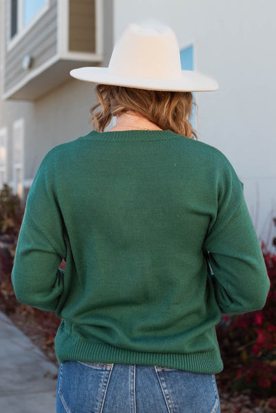 Back view of the merry green crewneck sweater