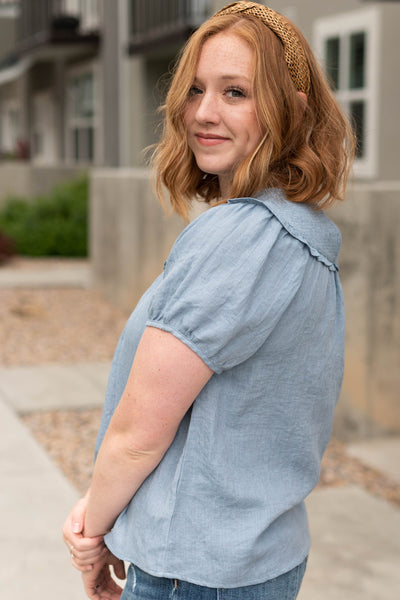 Side view of a short sleeve chambray top