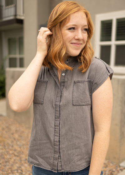 Light grey denim top that buttons up and has a collar