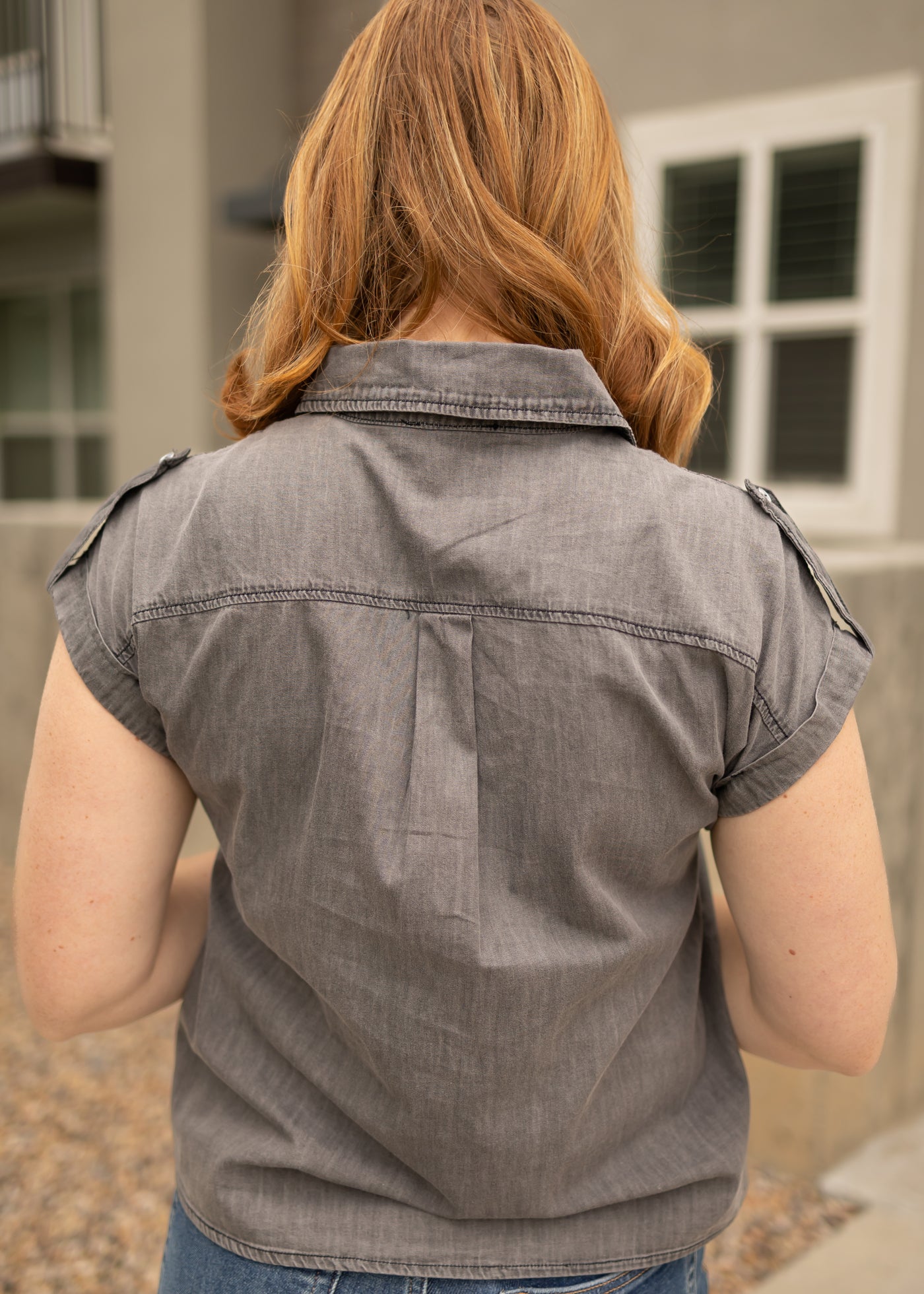 Back view of a light grey denim top