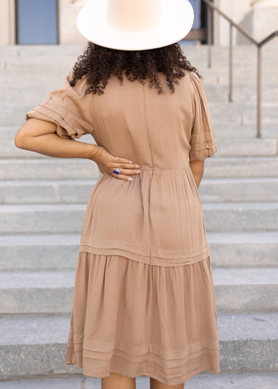 Back view of a short sleeve taupe dress