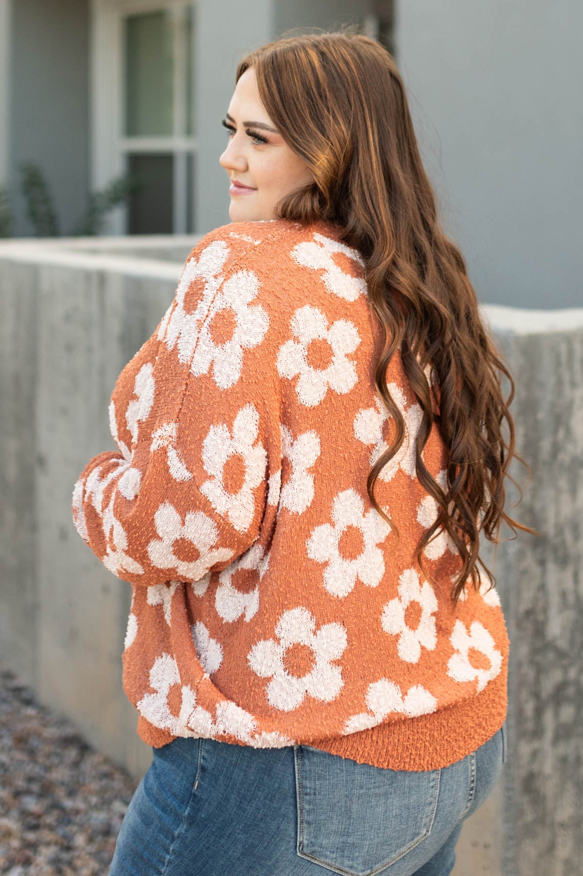 Side view of a plus size caramel sweater
