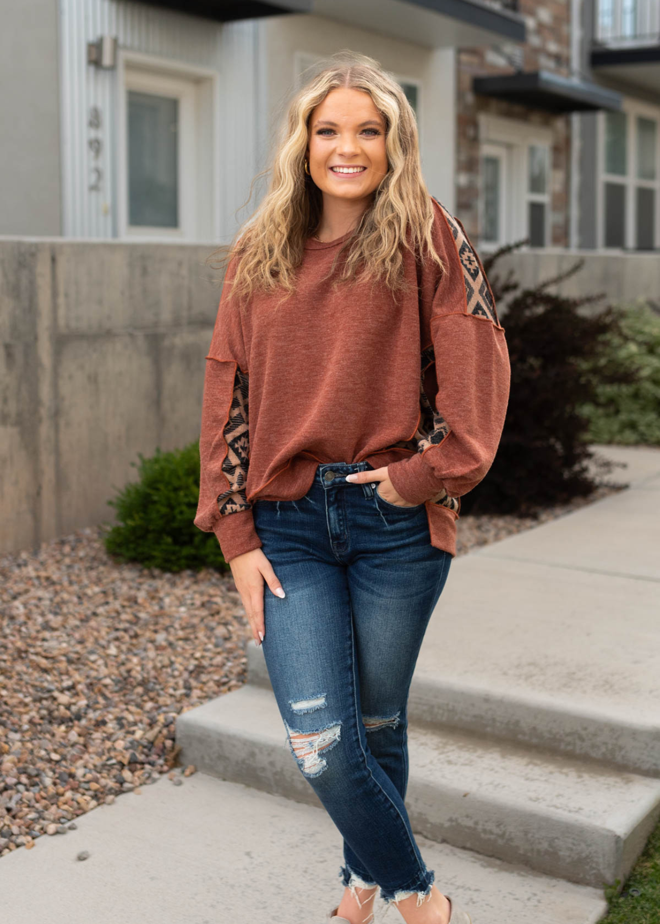 Long sleeve rust top with fabric panel on shoulders