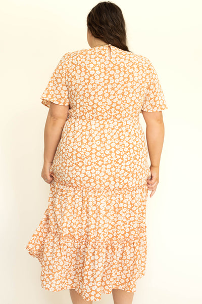 Plus size short sleeve apricot dress with white flowers and a V-neck.
