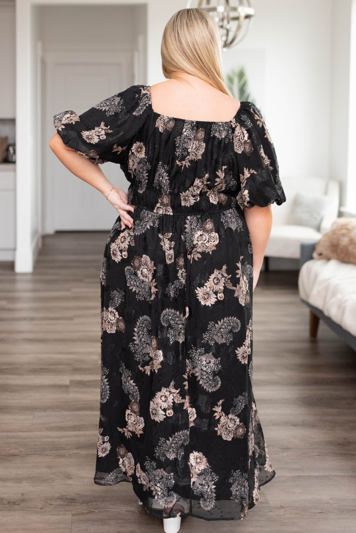 Back view of the a plus size black pattern dress