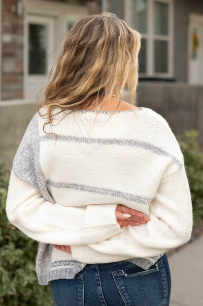 Back view of a white grey striped sweater