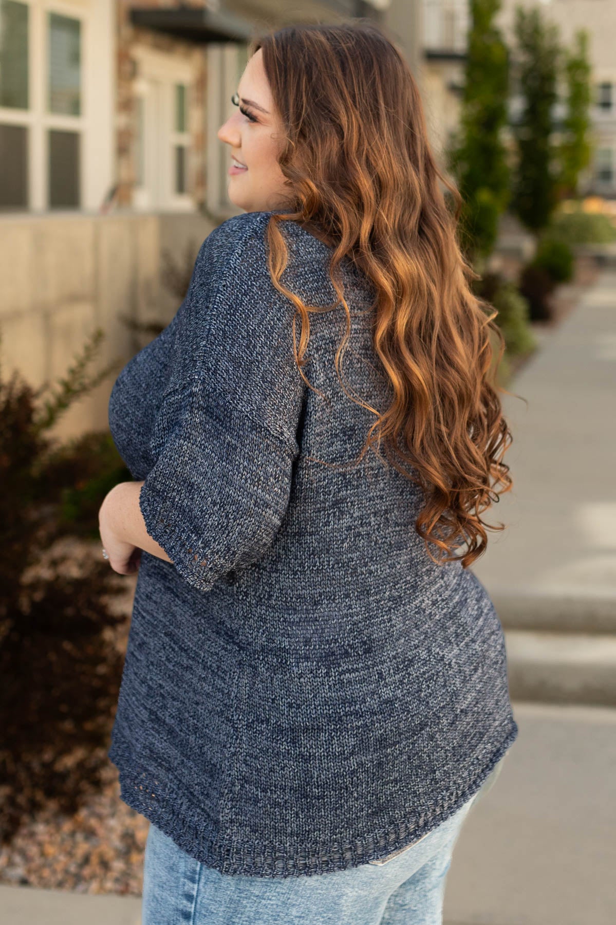 Side view of a plus size navy top