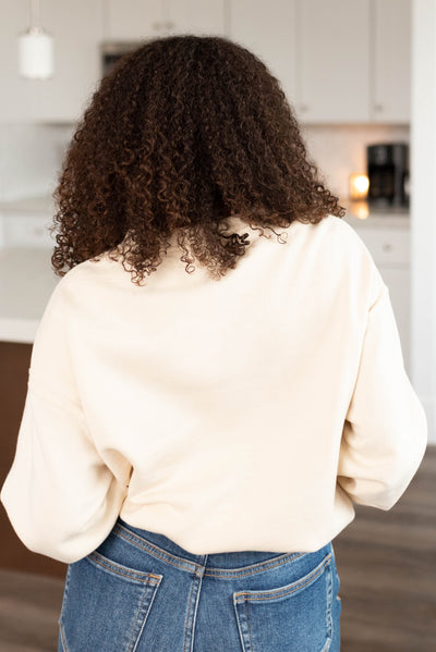 Back view of a cream fleece sweatshirt