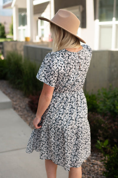 Back view of an ivory dress with black flowers