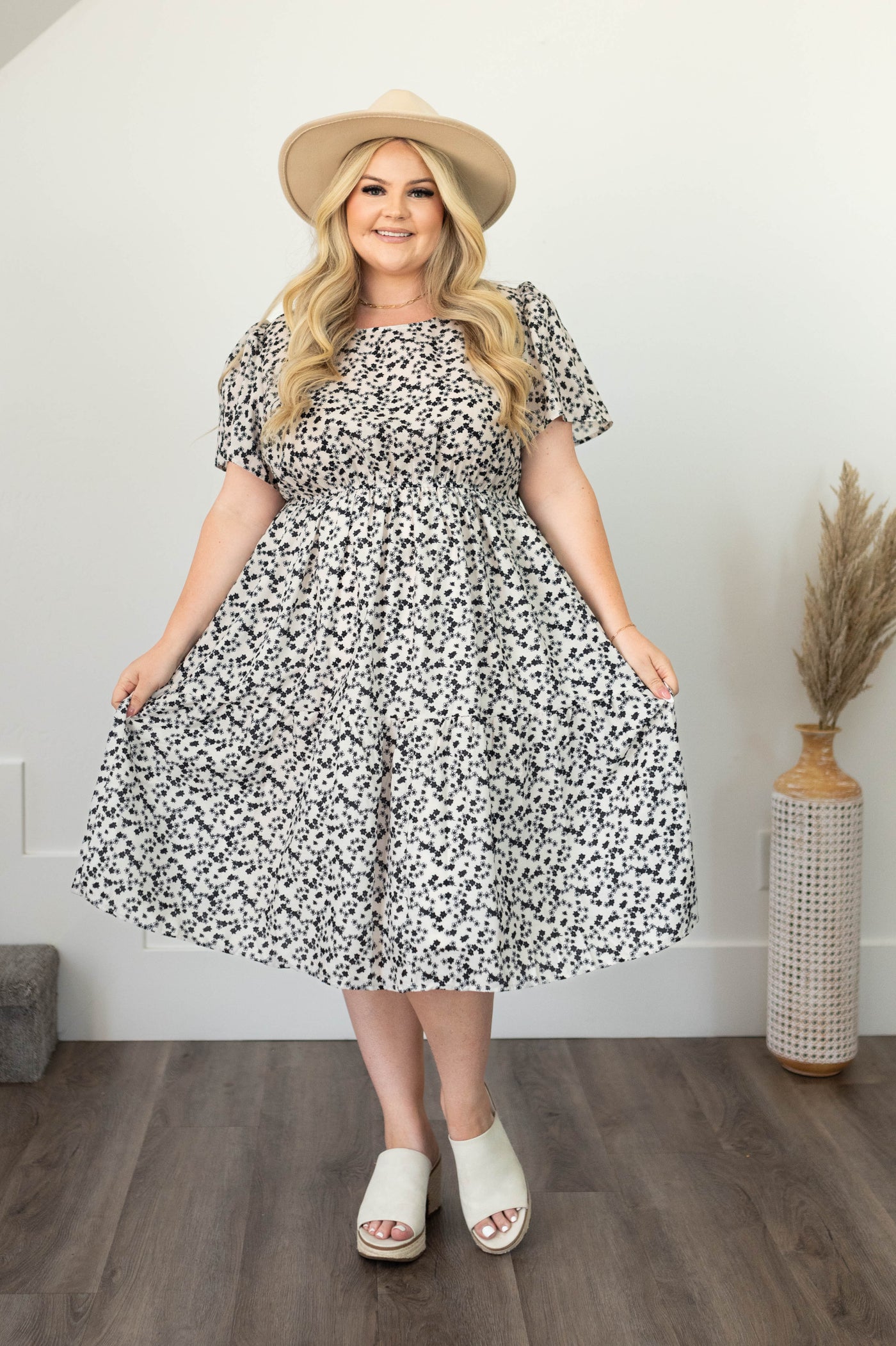 Ivory dress with short sleeves and a black flower print