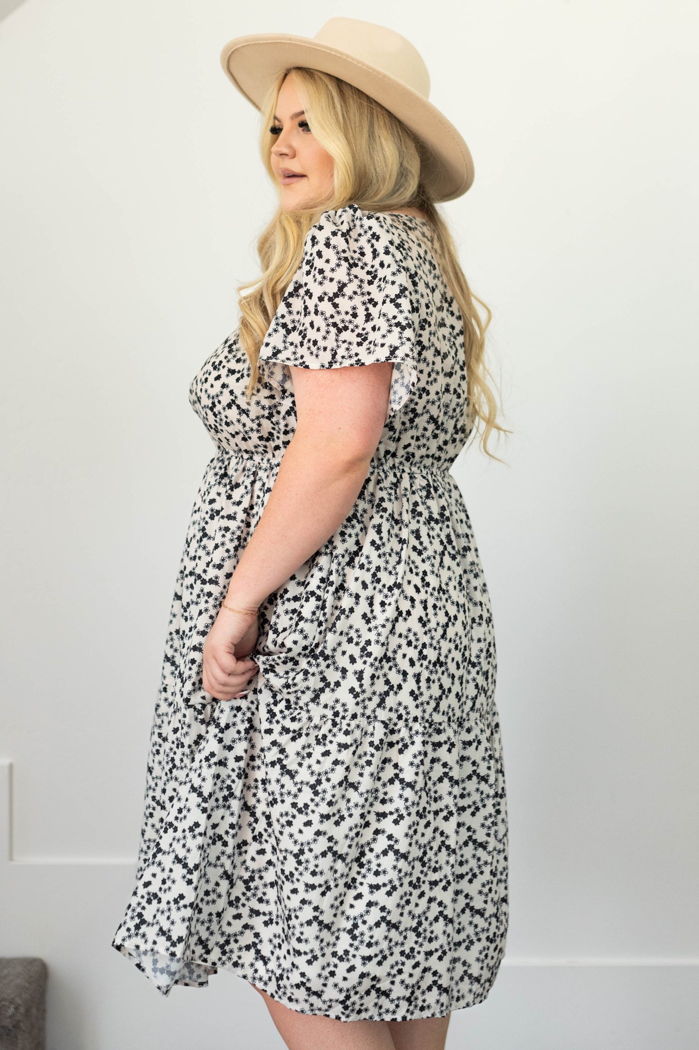 Side view of a plus size ivory dress