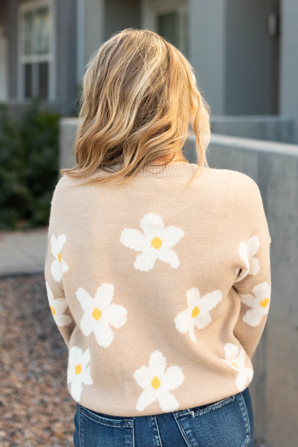 Back view of a beige sweater