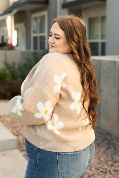 Side view of a plus size beige sweater