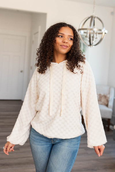 Long sleeve ivory fuzzy checkered sweater with a hood