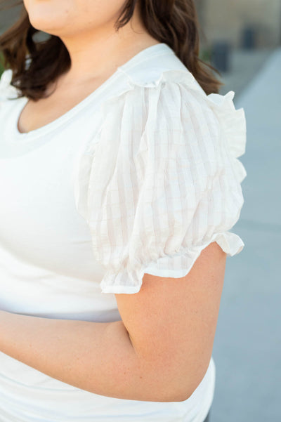 Sleeve of a short sleeve plus size white top