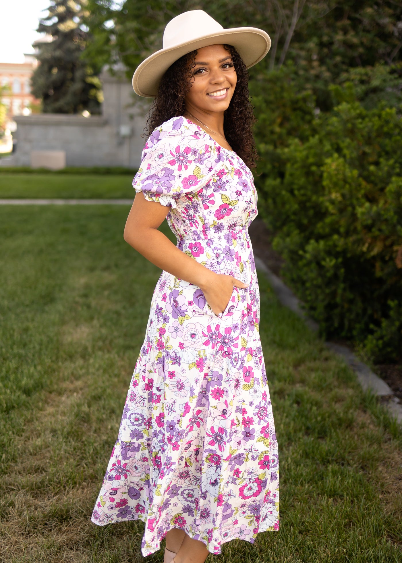 Side view of a short sleeve purple floral dress
