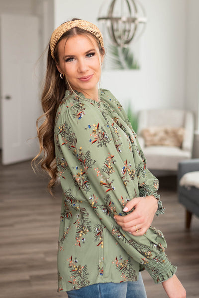 Side view of a sage floral blouse