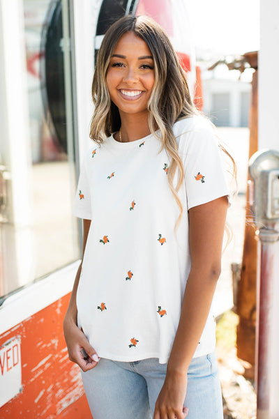 White top with coral flowers